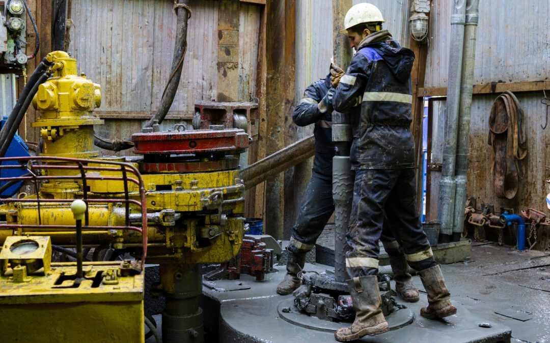 Offshore oil rig worker prepare tool and equipment for perforation oil and gas well at wellhead platform. Making up a drill pipe connection. A view for drill pipe connection from between the stands.