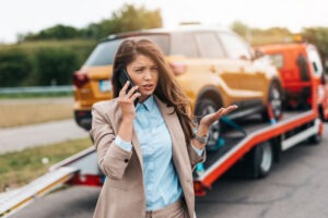 A woman on the phone after a car accident. What steps should I take after a car accident in Texas?