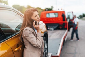 A woman on the phone after a truck accident. What steps should I take after a truck accident in Texas?